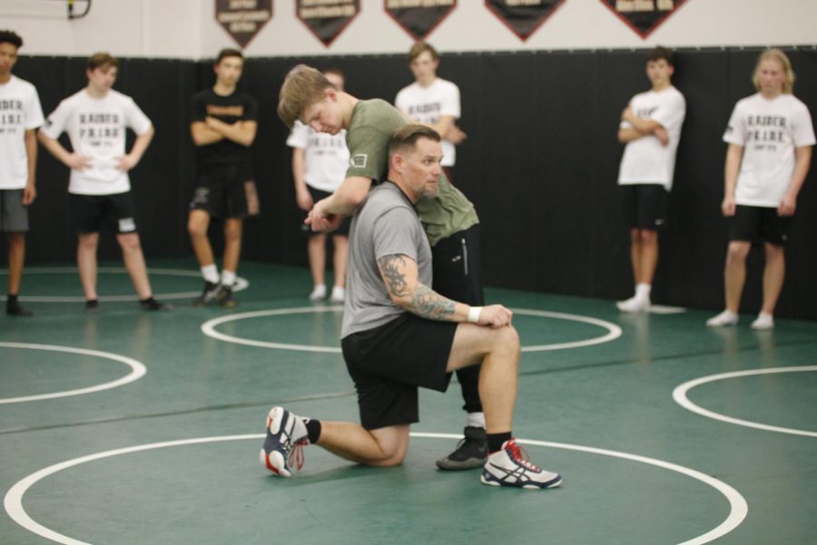 READY TO RUMBLE 
Senior Thomas Tolbert and new wrestling coach Lehi Benton demonstrate a fundamental move for team members during an after-school practice. 