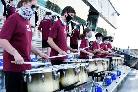 Drumline performs at the Friday night football game.