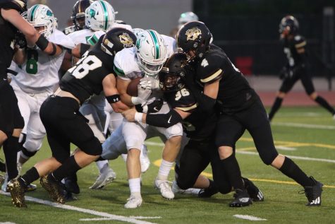 Working together, senior defenders Ashton Davis and Christian Lyons work to take down the ball carrier.