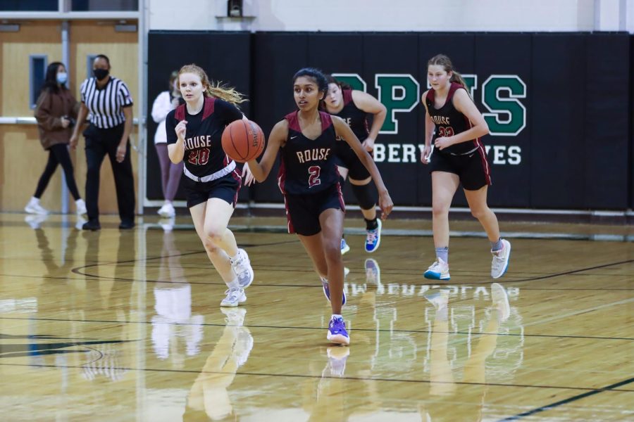 During a JV game, junior Meghana Pulimi dribbles down toward the basket. 