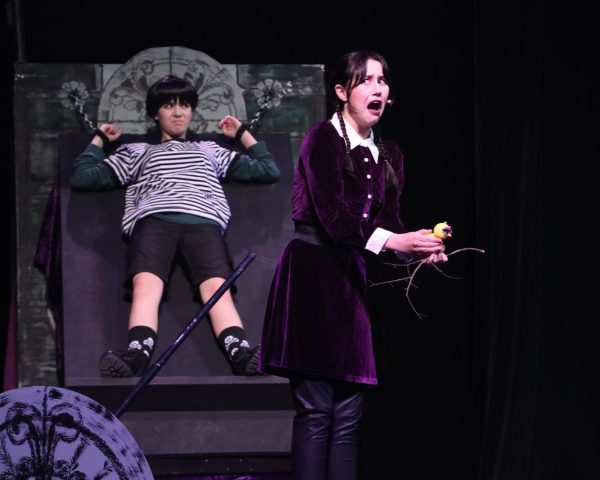 In “Pulled” performing with freshman Amelia Ogden, sophomore Kinsley Keen portrays Wednesday Addams. Keen has been a part of the musical for two years. “Surprisingly when I performed ‘Pulled, I never felt nervous,” Keen said. “I think I’ve sung that song so many times that I went on autopilot. I think having Pugsley onstage with me was comforting at times so I wasn’t completely alone though.”