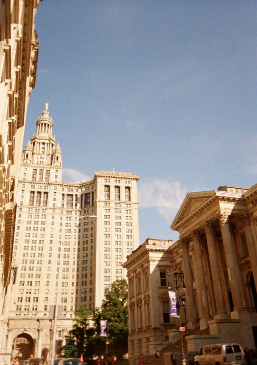 While walking down to the Brooklyn Bridge, junior Faye Zayed takes a photograph of the building in front her her. It was her first time visiting New York. "It was so beautiful," Zayed said. "I loved every minute of it." 