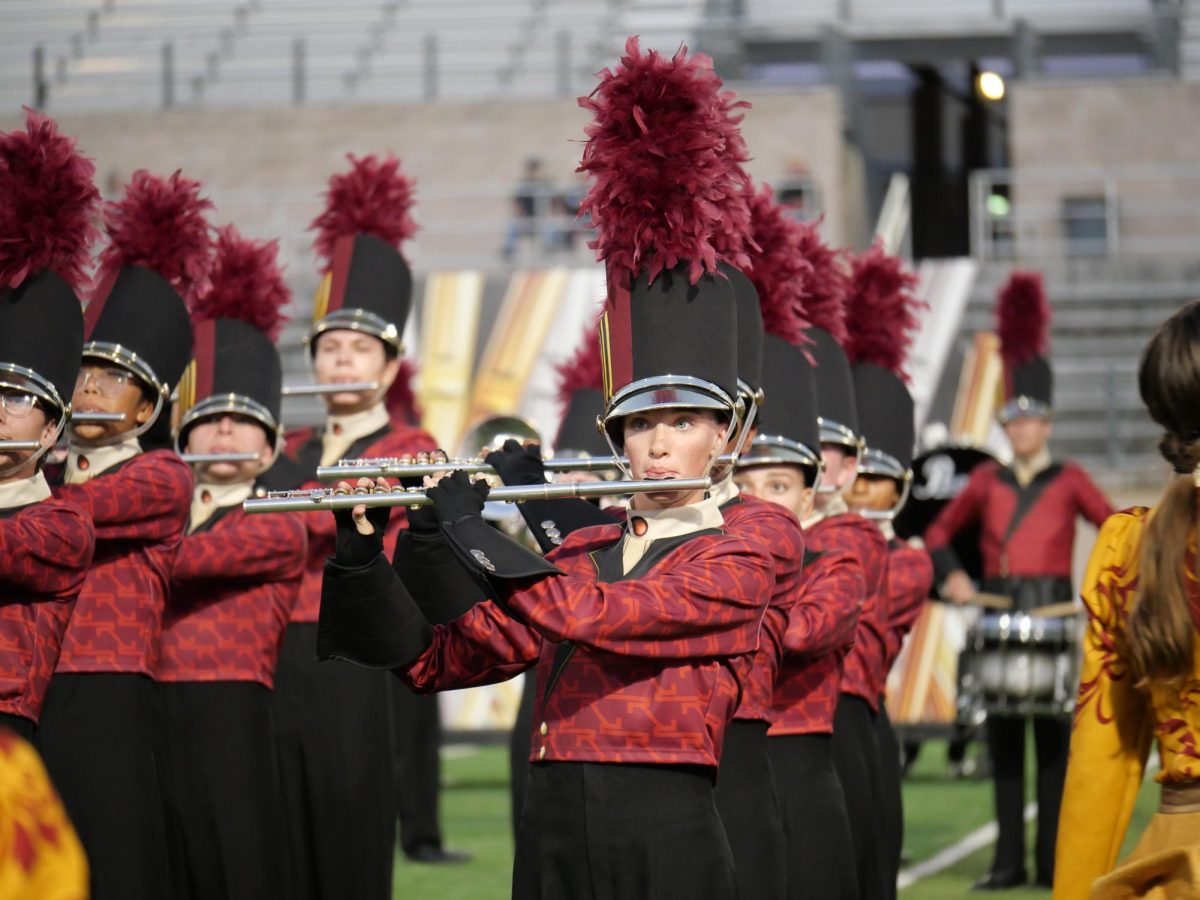 Pride & Passion: With her bandmates, junior Ariana Stanfield plays the flute during the halftime show rehearsal. Stanfield described being a changed, more responsible person after being in band. “It’s given me leadership skills that I thought I would never have,” Stanfield said. “It’s just made me a better person overall.” 
