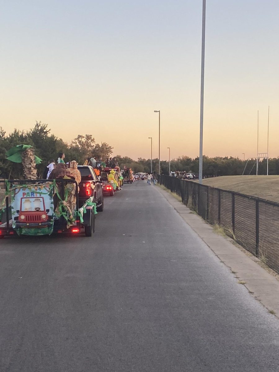 Watch out: Multiple floats with students representing various teams and clubs line up waiting to throw candy at trick or treaters up the road. They were located behind one of the Rouse fields in the bus lanes.