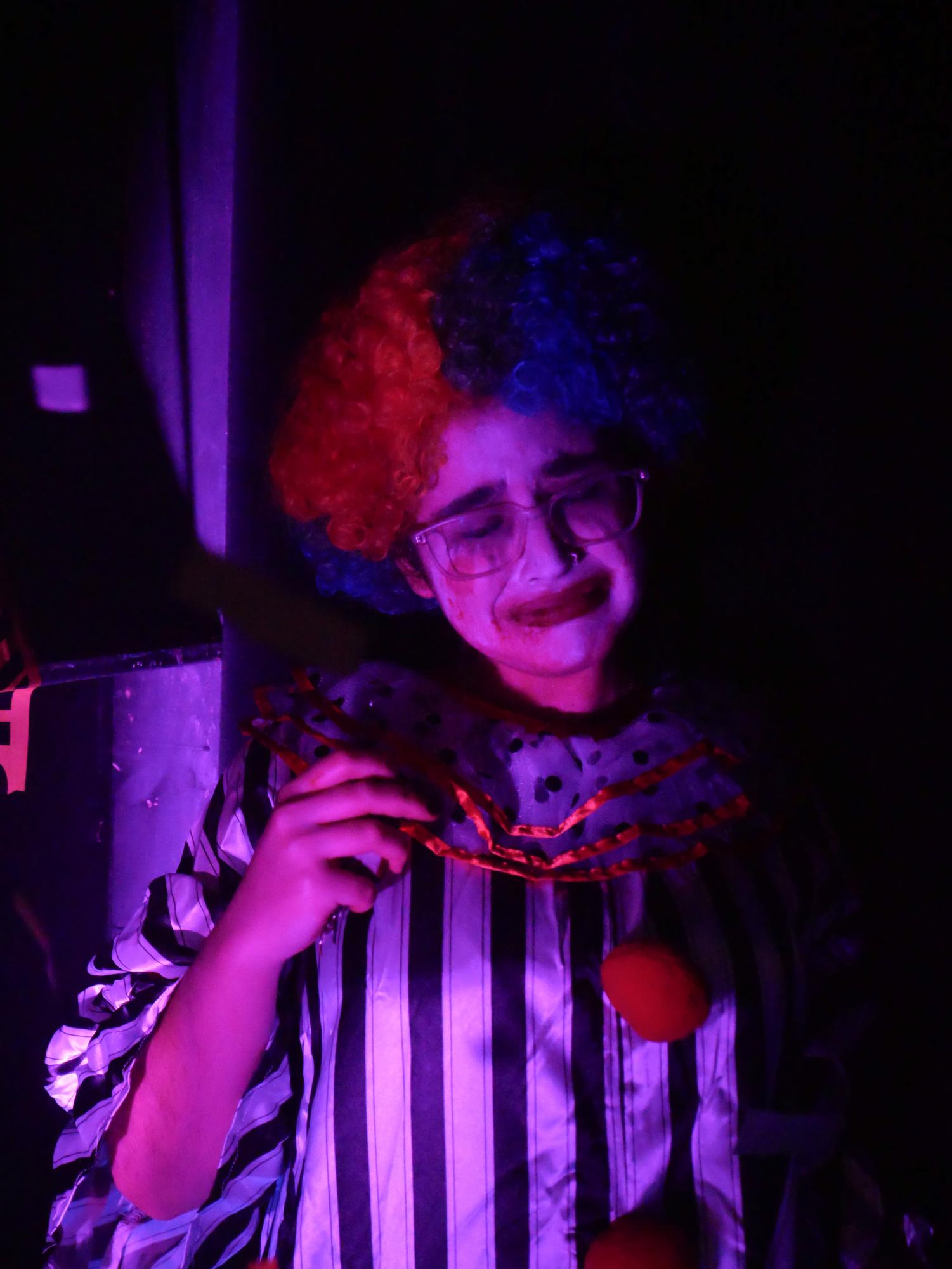 spook & scare: Into the entry way of Rouse of Torment, senior Talia Assouline welcomes in new company dressed as a clown. Assouline participated in the attraction last year and decided to give it another go. “I thought it was so fun not just to scare people but to be able to be in a little environment full of your friends,” Assouline said. “You’re all acting as a creature, I thought it was cool.” 