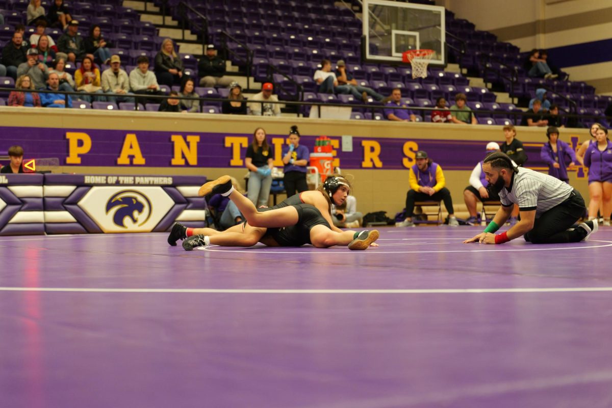 At a Liberty Hill game, senior Isabella Sandoval pins down her opponent.