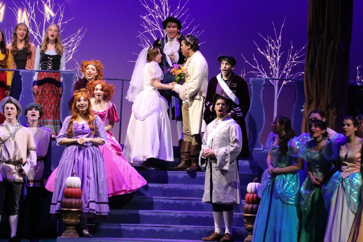 Surrounded by townspeople, Cinderella and Prince Topher stand on the steps of the chapel nearing the end of the production.