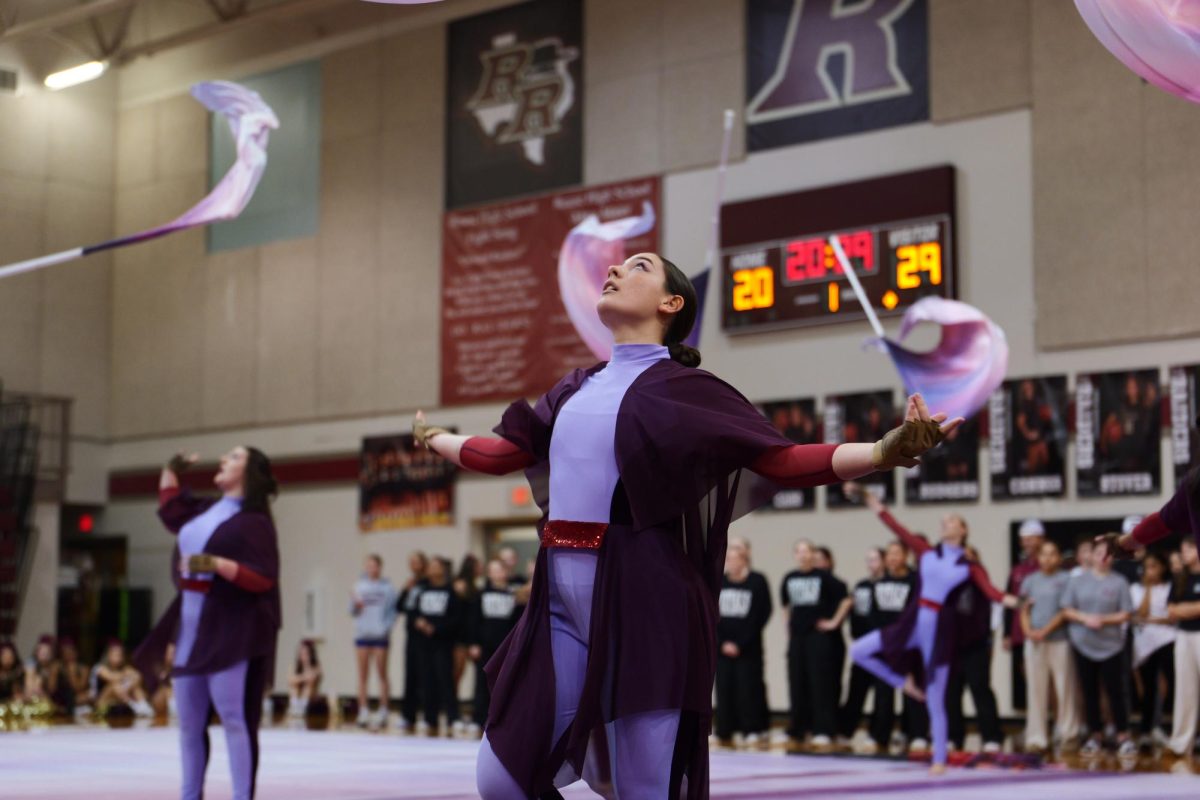 In synchronizing form, junior Alexandra Heyman awaits her flag to drop back into her hands. They had been practicing the performance that they performed for the 8th graders since the end of football season. “For me, I joined when I was in middle school so I think having younger kids see it and showing them things they might like to do is really important to see if they want to join and be a part of something new,” Heyman said.
