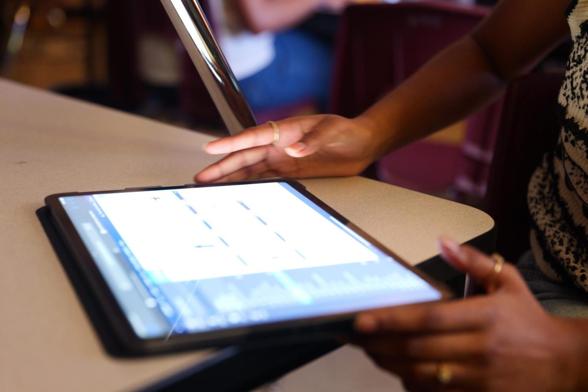 This photo was taken in 2024 prior to new legislation. Senior Neha Allamneni regularly used an iPad to create cutouts for yearbook, but now due to HB 1481 iPads are no longer permitted in the classroom. 

