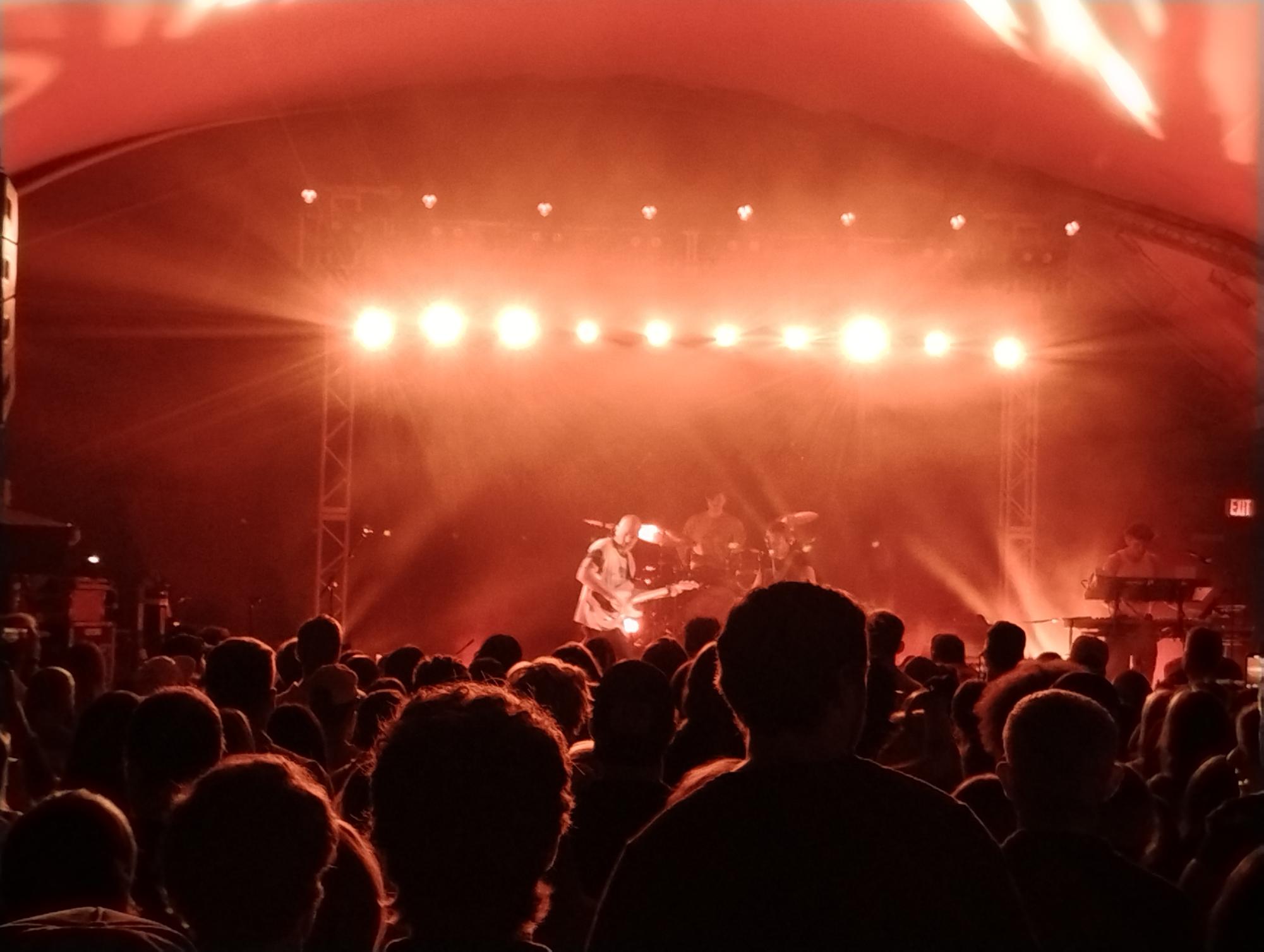 At the concert, Juni Davila photographs the stage.