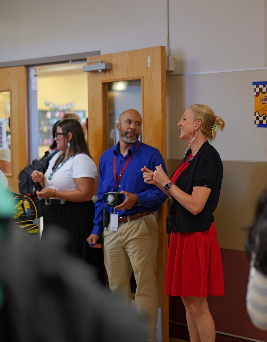 Assistant Principal Dr. Bates and Principal Vincent Hawkins greet students at the R during passing period.
