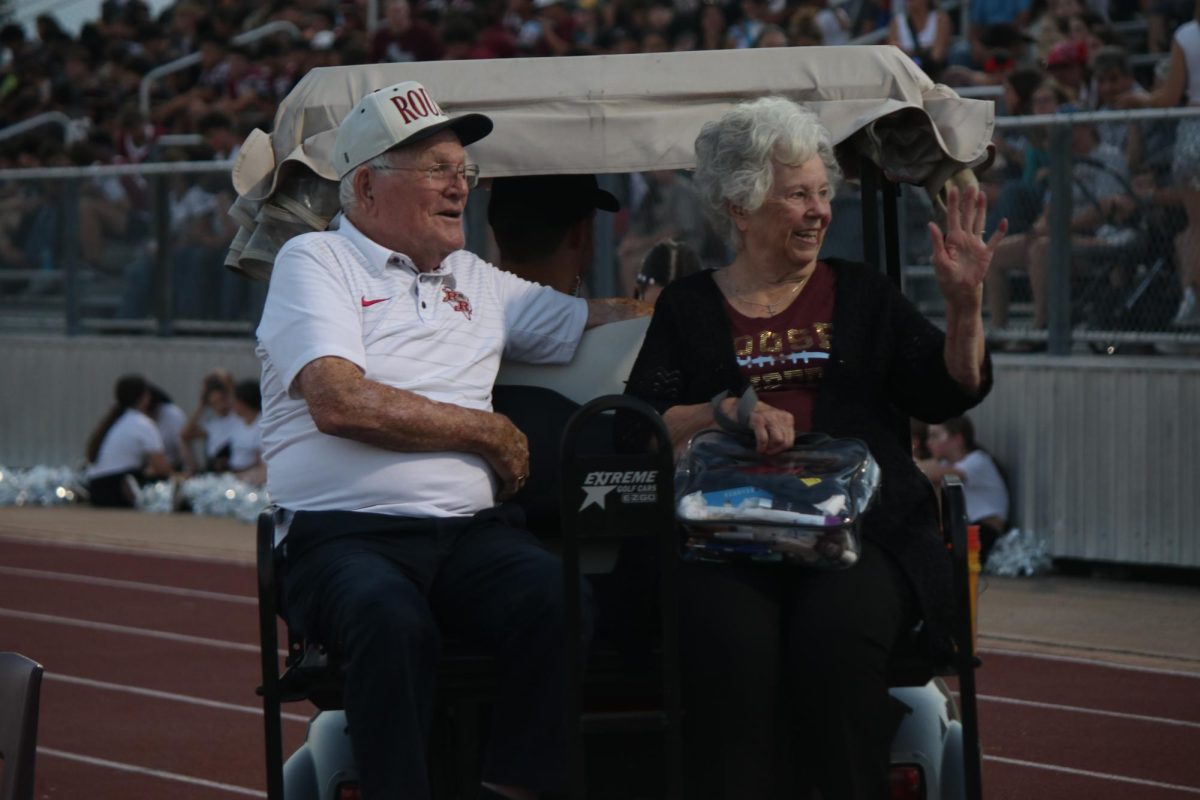 Mr and Mrs Rouse wave and greet students and staff at the homecoming parade. Photo by Katie Mathews.