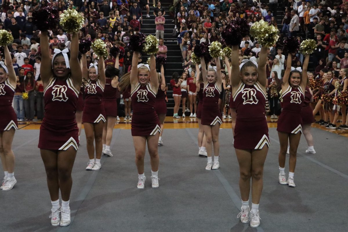 The cheer team riles up the crowd at the homecoming pep rally.