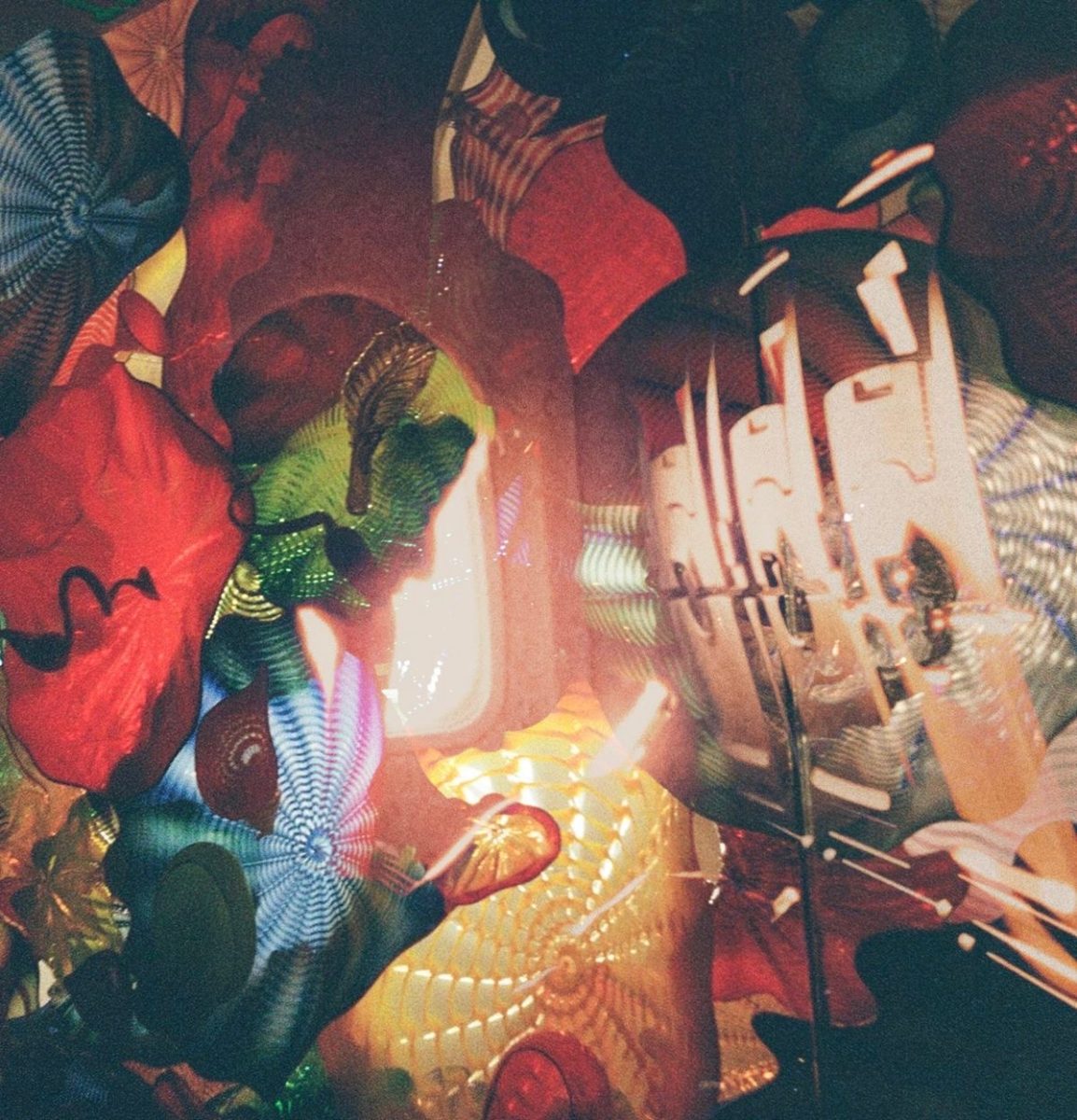 Art of Film: As senior Faye Zayed's sister looks down at her phone, Zayed takes a photo using film. Zayed later edited the film photo, with another film photo of glass art, to make it seem like double exposure. "This is what I hope 2026 feels like," Zayed said. "We need colors back into our lives."
